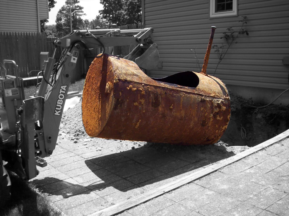 A photo of an underground oil tank being removed from a patio